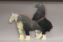 Three painted metal cut outs of shire horses. 48 cm long.