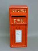 A red post box. 57 cm high.