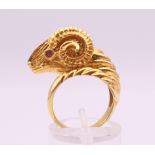 An 18 ct gold ruby and diamond ram's head form ring. Ring size K. 12.8 grammes total weight.