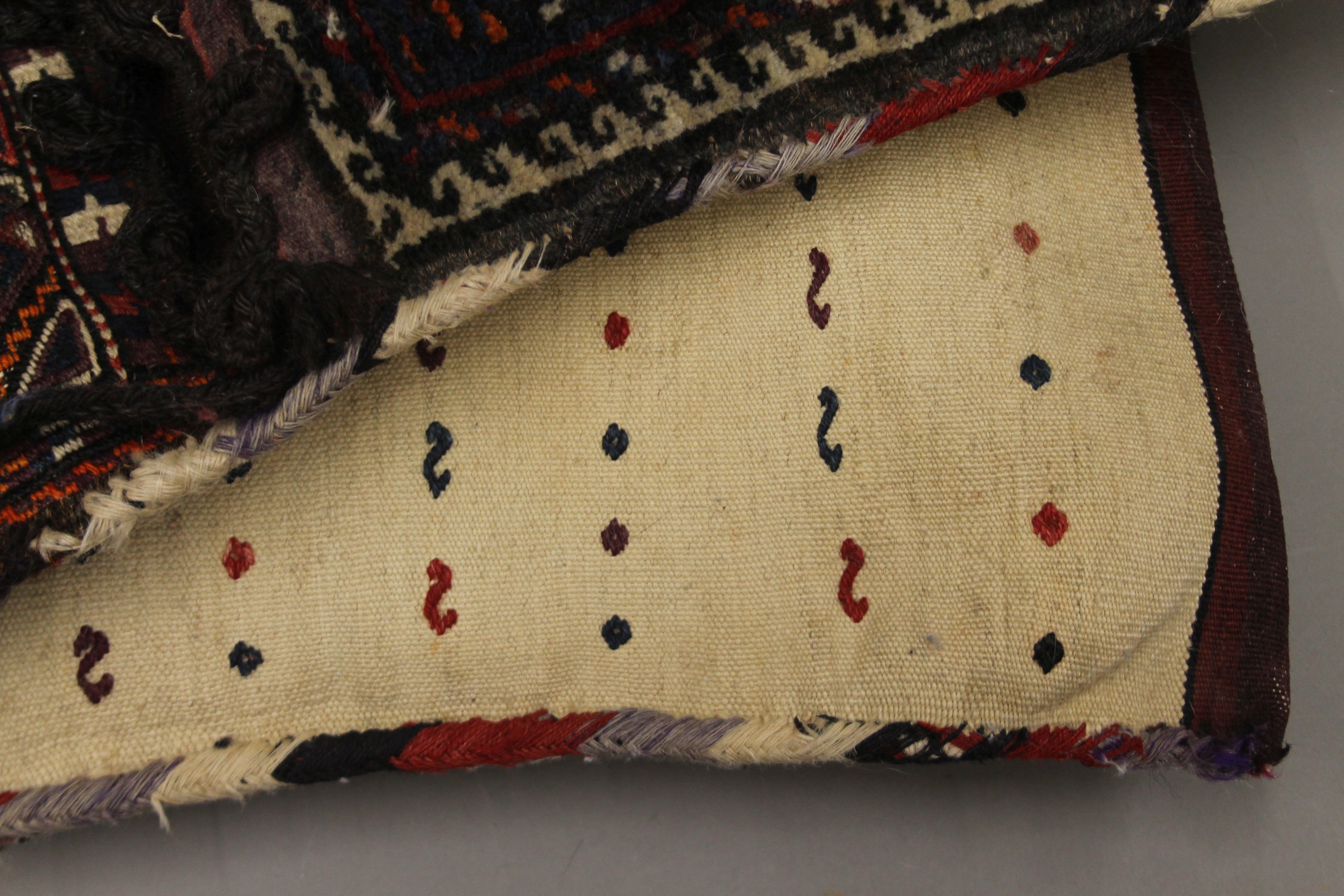 A Persian saddle bag rug and two cushions. The former approximately 98 cm long. - Image 3 of 5