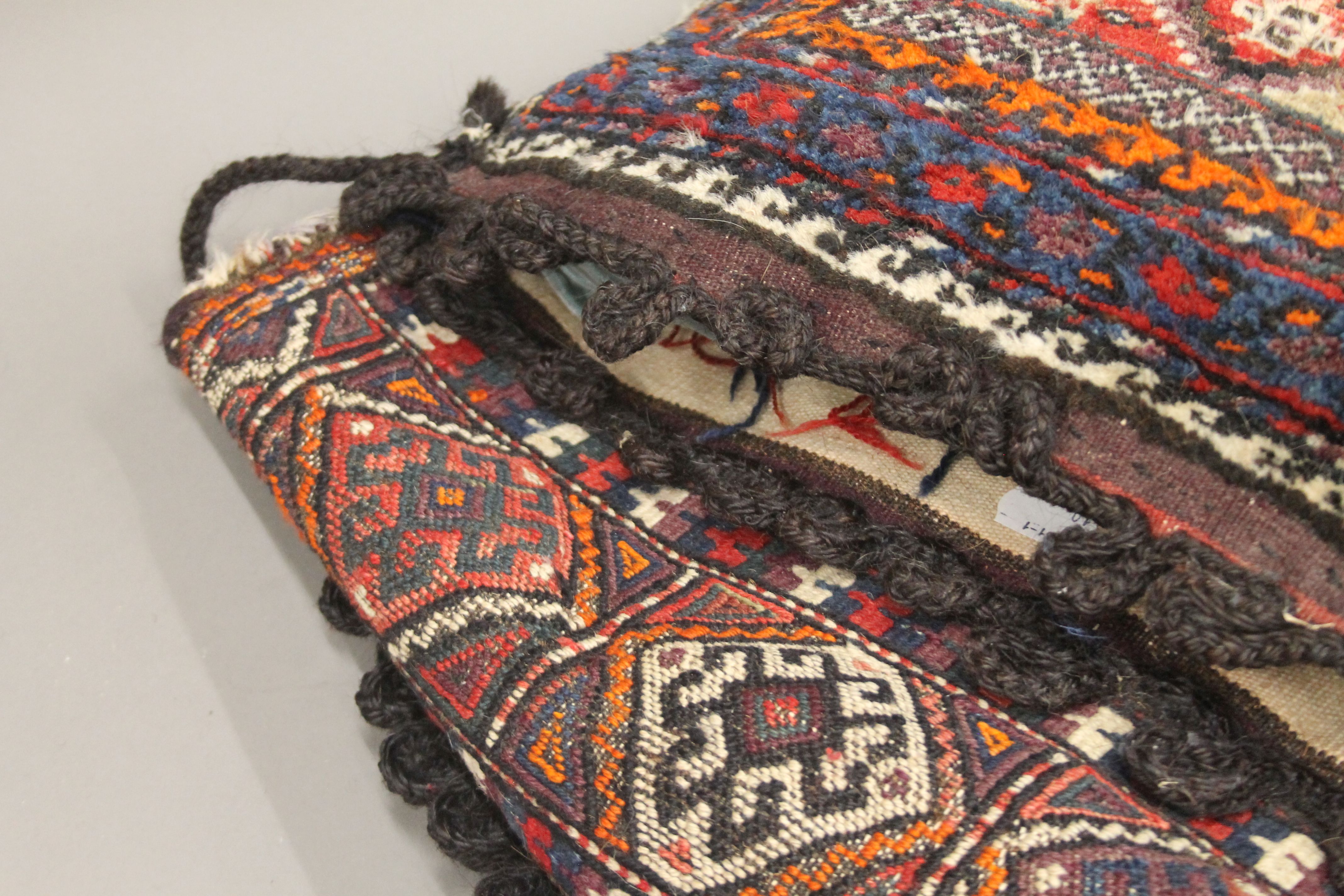 A Persian saddle bag rug and two cushions. The former approximately 98 cm long. - Image 2 of 5