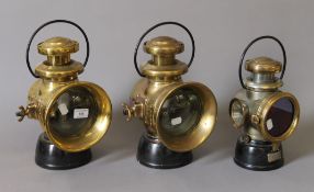 Three Lucas King of the Road lamps. The largest 34.5 cm high.