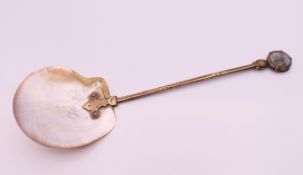 A 19th century spoon with mother-of-pearl bowl and Man in the Moon finial. 22 cm long.