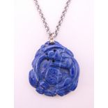 A carved lapis dragon pendant on chain. Pendant 4 cm high, chain 66 cm long.
