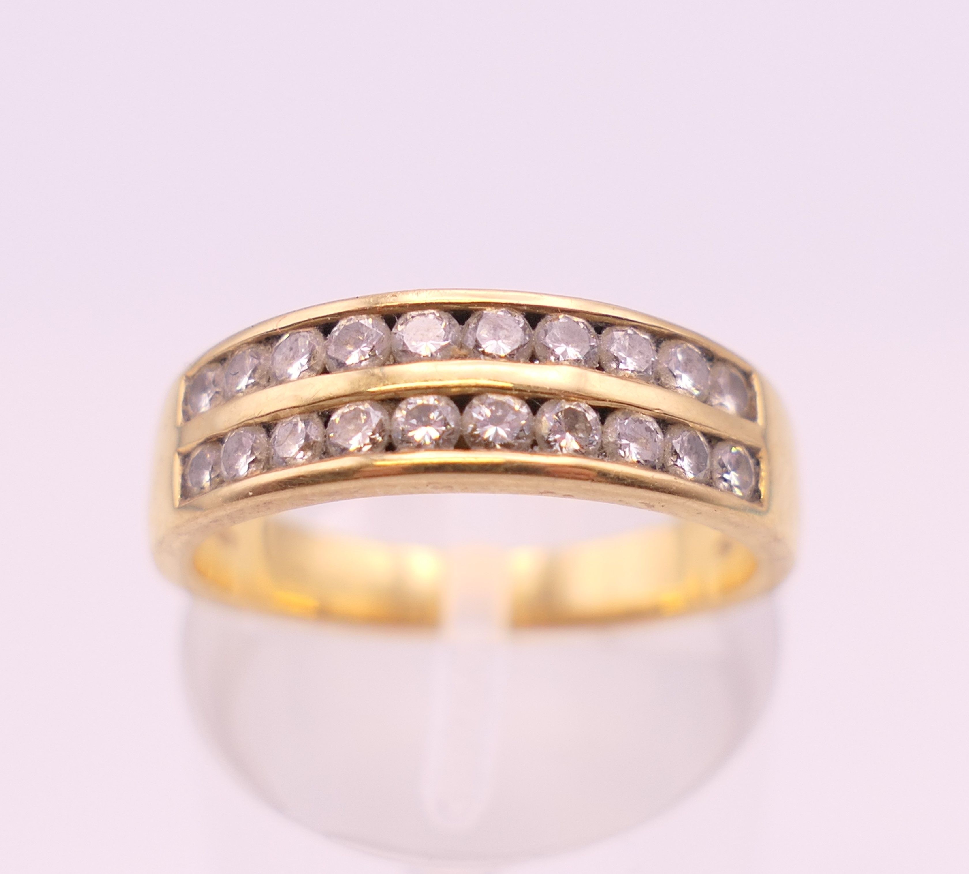 An 18 ct gold diamond ring. Ring size M. 4.4 grammes total weight.