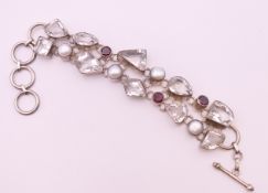 A silver multi gem and pearl bracelet.