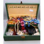 A jewellery box containing a large quantity of costume jewellery.