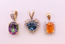 Three 9 ct gold pendants, each set with diamonds. The largest 1.5 cm high including suspension loop.