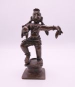 A small Indian bronze deity. 10 cm high.