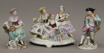 A pair of Sitzendorf figures and porcelain figural group. The latter 20 cm high.