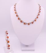 A matching amber and silver necklace and bracelet.