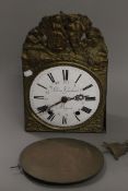 A 19th century French pressed brass wall clock. 39 cm high.