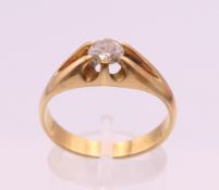 An unmarked gold diamond solitaire ring. The stone spreading to approximately 0.5 carat.