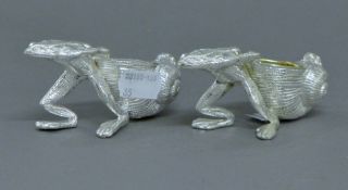 A pair of silver plated frog and shell salts. 10 cm long.