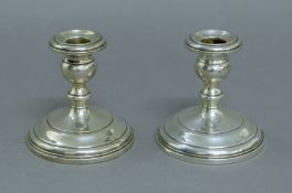 A pair of silver candlesticks. 10 cm high.