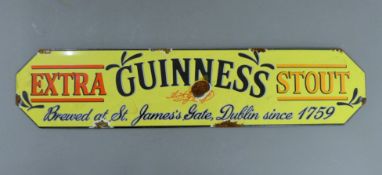 An enamel Guinness sign. 57 cm long.