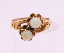 A 9 ct gold and opal ring. Ring size J/K. 1.8 grammes total weight.