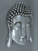 A silvered wall hanging Buddha mask. 57 cm high.