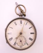 A silver pocket watch. 4.75 cm diameter.