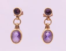 A pair of 9 ct gold amethyst earrings. 2 cm high.