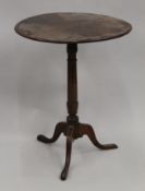 An oak tilt top tripod table. 57 cm diameter.