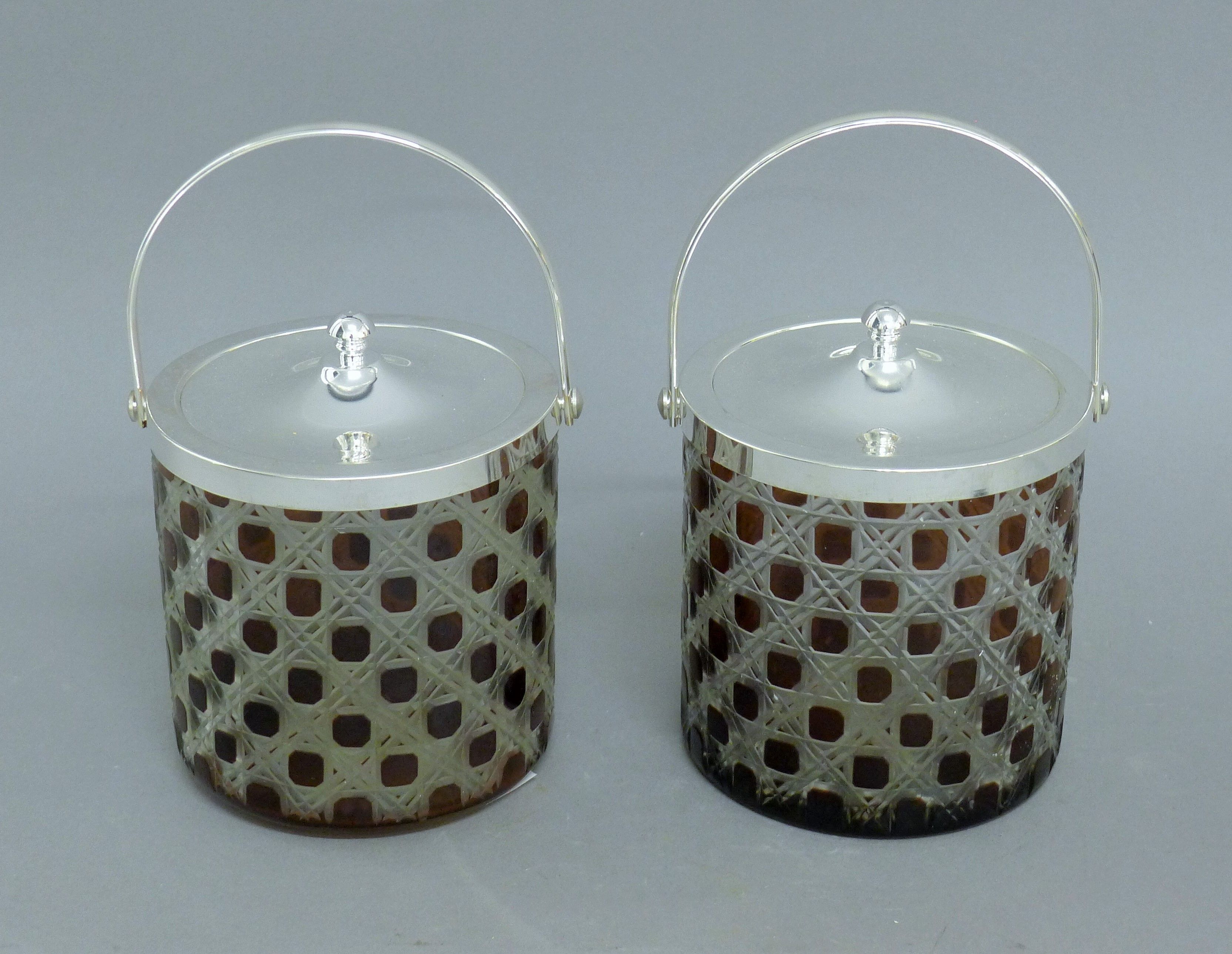 A pair of silver plated and ruby glass biscuit barrels. 21 cm high overall.
