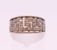 A 9 ct white gold Greek key design diamond set ring. Ring size L. 2.8 grammes total weight.