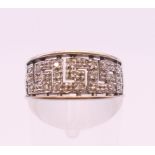 A 9 ct white gold Greek key design diamond set ring. Ring size L. 2.8 grammes total weight.