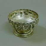 An Indian silver bowl with repousse decoration of rural scenery. 10 cm diameter. 85.9 grammes.