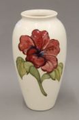 A large William Moorcroft white ground vase decorated in the Hibiscus pattern, W.