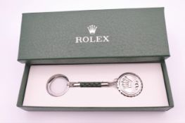 A key ring stamped Rolex, new in box.