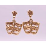 A pair of 9 ct gold earrings formed as comedy and tragedy theatre masks. 2.