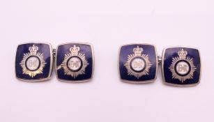 A pair of enamel police cufflinks. 1.5 cm square.