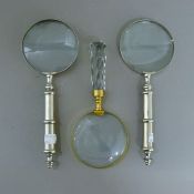 Three various magnifying glasses.