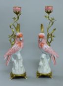 A pair of bronze and porcelain pink parakeet form candlesticks. 42 cm high.