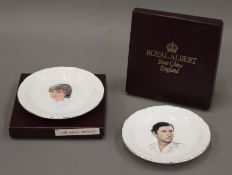 A pair of boxed Royal Albert Charles and Diana dishes.