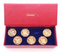 A set of six Cartier silver gilt buttons.