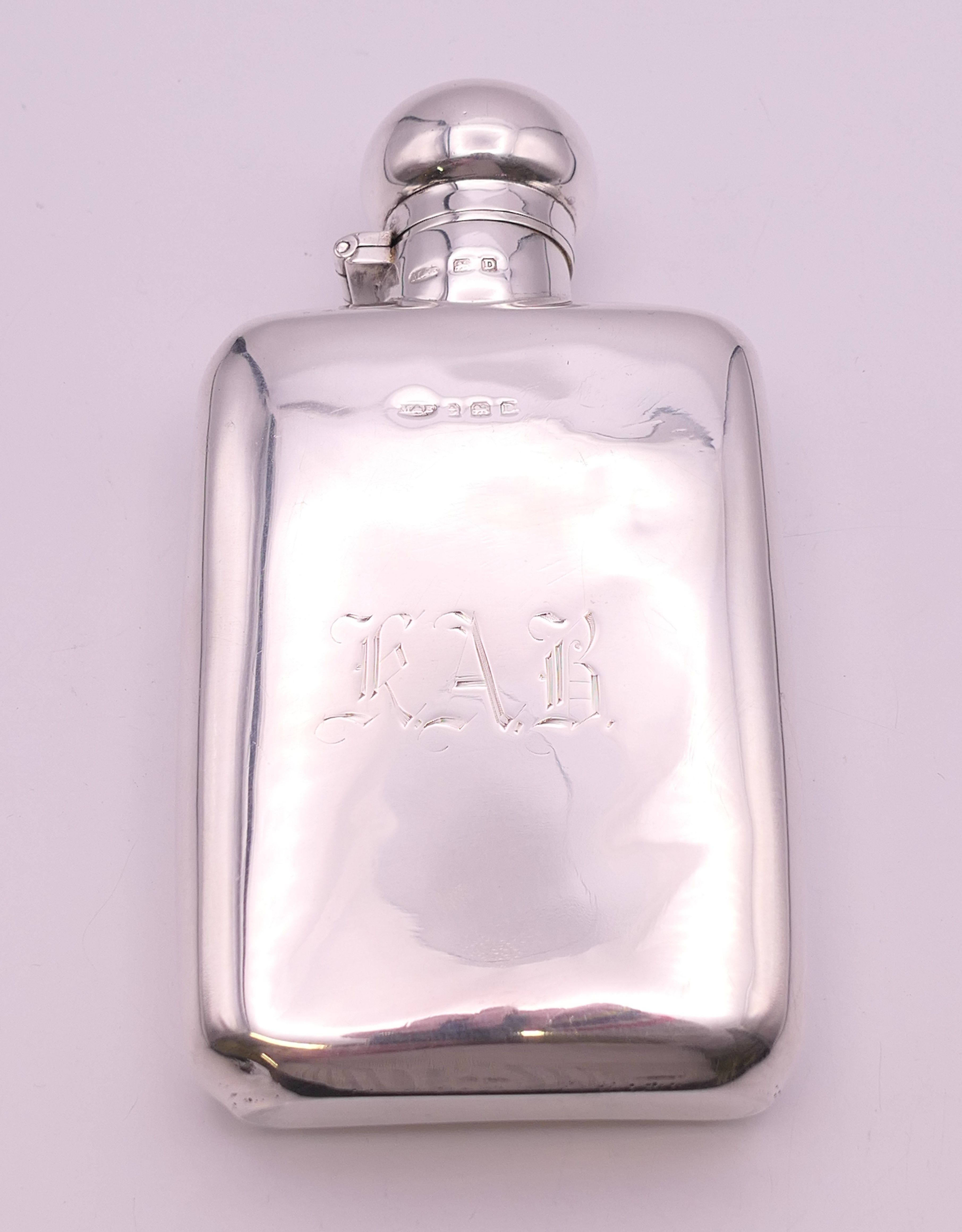 A silver spirit flask of typical form, Birmingham 1928. 14 cm long. 146.9 grammes.