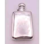 A silver spirit flask of typical form, Birmingham 1928. 14 cm long. 146.9 grammes.