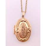 A 9 ct gold double photo locket on a 9 ct gold chain. The locket 3 cm high. 5.7 grammes.