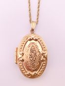 A 9 ct gold double photo locket on a 9 ct gold chain. The locket 3 cm high. 5.7 grammes.