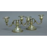 A pair of silver candelabra. 21.5 cm wide.
