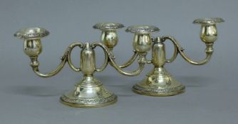 A pair of silver candelabra. 21.5 cm wide.