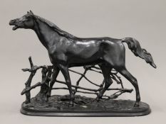 A patinated cast iron model of a horse. 39 cm long.