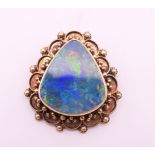 A 14 ct gold opal brooch. 3.5 cm high. 13.4 grammes total weight.