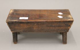 A small 19th century elm stool. 29 cm wide.