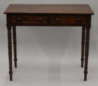 A Victorian mahogany two drawer side table. 91 cm wide.