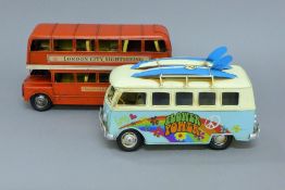 A tin model of a London bus and a VW campervan. The former 28 cm long.