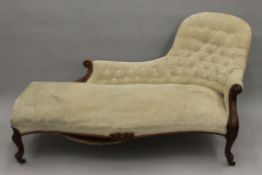 A Victorian mahogany framed white button upholstered chaise lounge. Approximately 170 cm long.