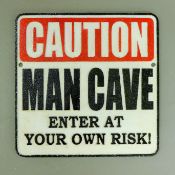 An iron Man Cave sign. 24.5 cm wide.